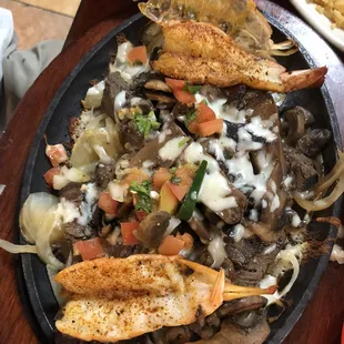 Steak and shrimp fajitas with side of rice and beans