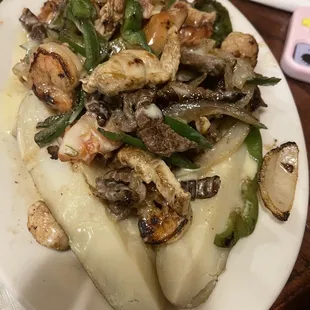 Steak, chicken and shrimp fajita baked potato