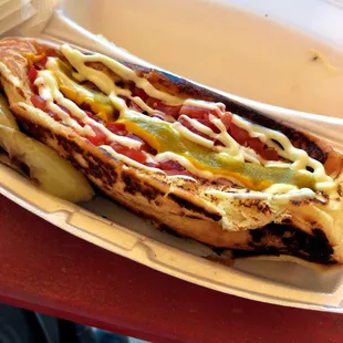 a hot dog in a styrofoam container