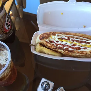 a hot dog in a styrofoam container