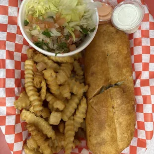 Steak chimichanga with toppings on the side