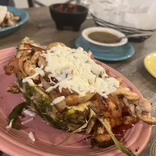 Sautéed shrimp, scallops and chicken served on a half pineapple