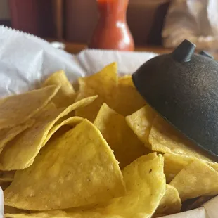 a bowl of chips and a drink