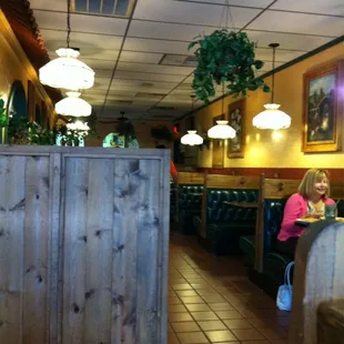a woman sitting at a table in a restaurant