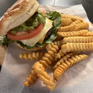 Dig into our deluxe burger with gooey cheese, fresh veggies, and zesty guac, paired with crispy fries!