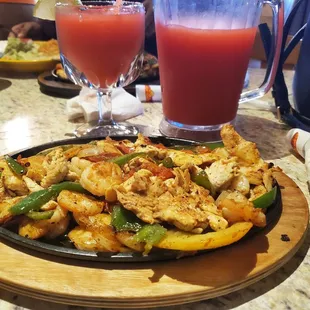 a plate of food and a glass of juice