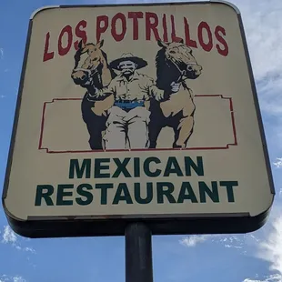 The sign next to Los Cerrillos, the road you will be driving on when you arrive.