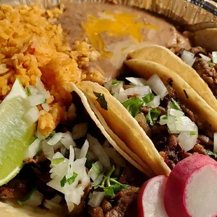 a plate of tacos and rice