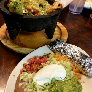 Molcajete includes a plate of Refried Beans, Tortillas, Salsa, Rice, Guacamole and Lettuce