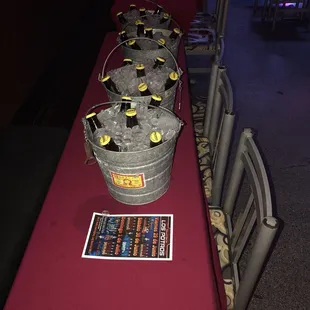 a long table with buckets of ice