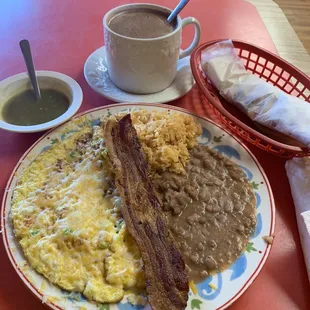 Omelette with bell peppers,onions bacon,beans and rice a hot chocolate and a homemade flour tortillas!!!