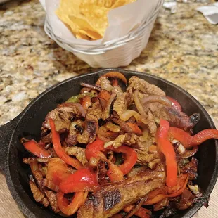 Lunch Fajitas (choice of chicken or steak), on a bed of mushrooms, onions and peppers.