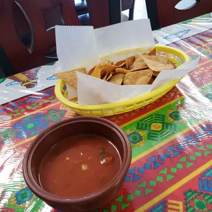 a bowl of tortilla and a bowl of salsa