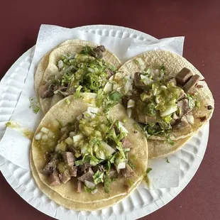three tacos on a paper plate