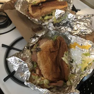 two sandwiches wrapped in foil