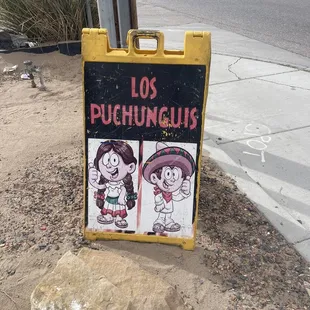 a sign on the side of the road