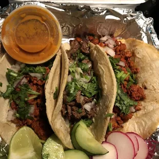 two tacos and a side of salsa
