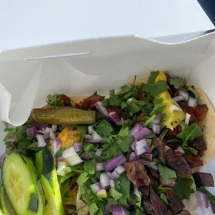 a taco with meat and vegetables