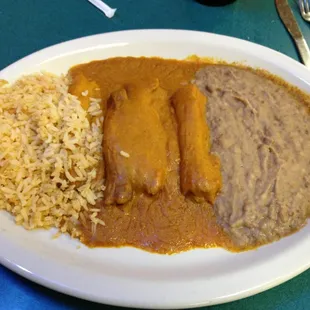 Tamale dinner with rice and beans.