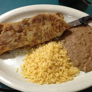 Milanesa with some rice and beans. Normally this comes with fries and rice, but I&apos;m Mexican so I opted for the beans.