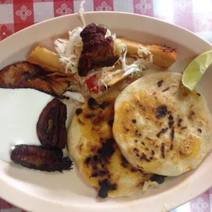 Combinado Tipica plate- $7.95 for 2 pupusas, plantains with cream, yucca frita, curtido and a piece of chicharron- yummo!!