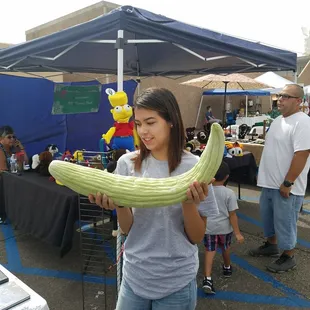 a woman holding a cucumber