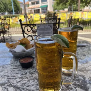 two glasses of beer on a table