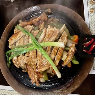 Chicken Fajitas, sizzling at your table.