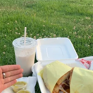 a person&apos;s hand reaching out to grab a sandwich