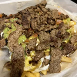 Carne asada fries: cheese sauce, sour cream, guac