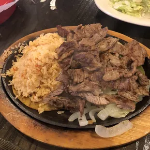 a plate of meat and rice
