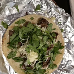Steak taco with cheese and cilantro