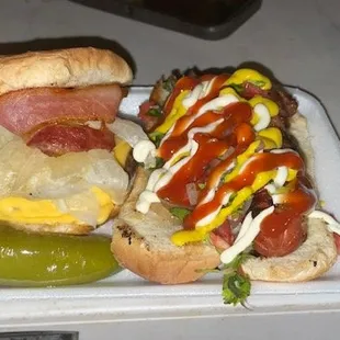 a plate of hotdogs and a pickle