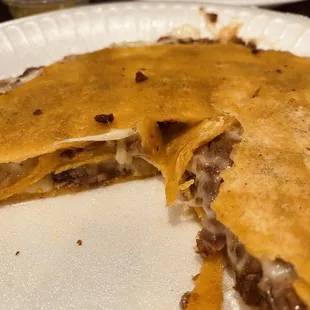 a close up of a taco on a paper plate