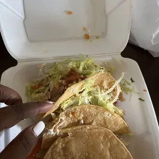 two tacos in a styrofoam container