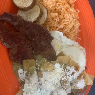 Chilaquiles (green) and carne plate with rice and potatoes as sides.
