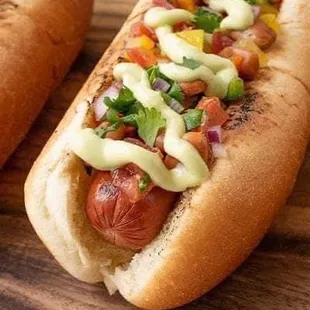 two hot dogs on a cutting board