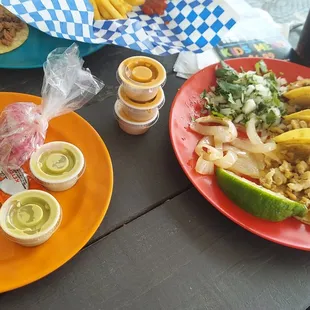 two plates of tacos and a drink