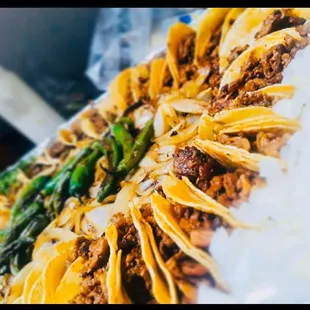 a plate of tacos and asparagus