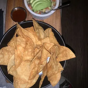 a plate of tortillas and a bowl of guacamole