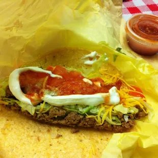 Beef taco on soft corn tortilla w tomato, peppers &amp; sour added.