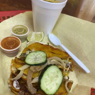 a plate of tacos and a drink