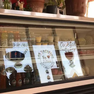 a display case with drinks