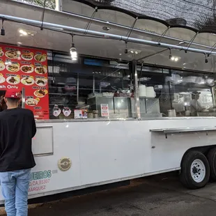 a man standing in front of a food truck