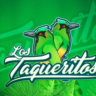 two green parrots perched on a branch