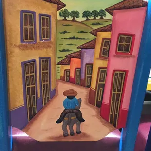 a child riding a horse through a town