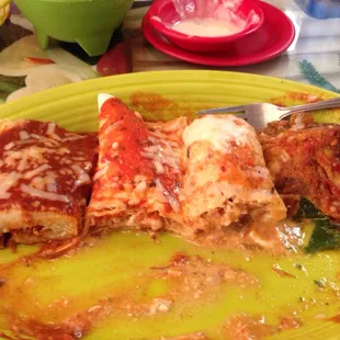 a plate of enchiladas with a fork