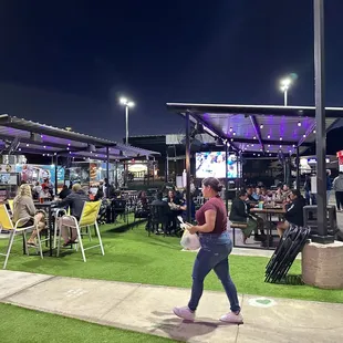 a group of people eating outside at night