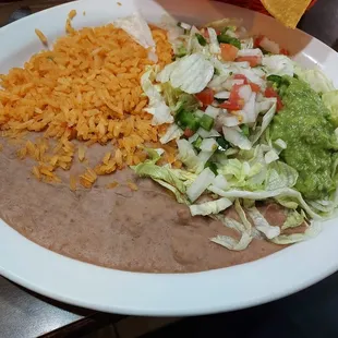 Beans, rice, and guac with lettuce, tomato, and unexpected jalapeno.