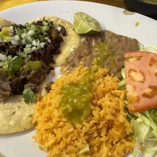 Tres Portillos taco platter with beans and rice.
